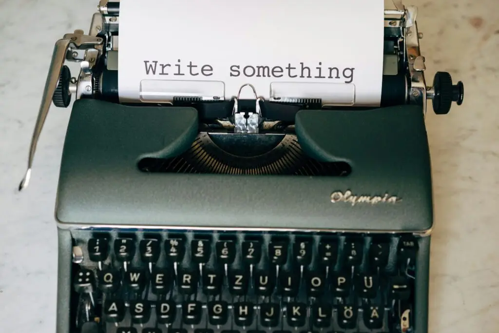 a typewriter with a sheet of paper that says "write something"